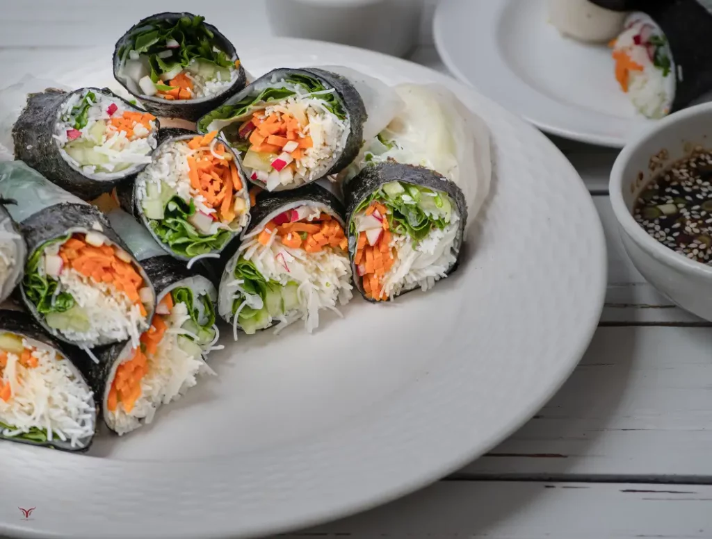 Close-up of a Vegan Spring Roll sliced in half, showing colorful vegetables inside.